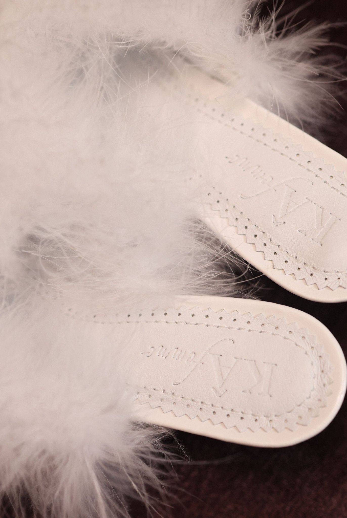 Close-up of the genuine leather insole with soft padding and the brand logo for a sense of quiet luxury.