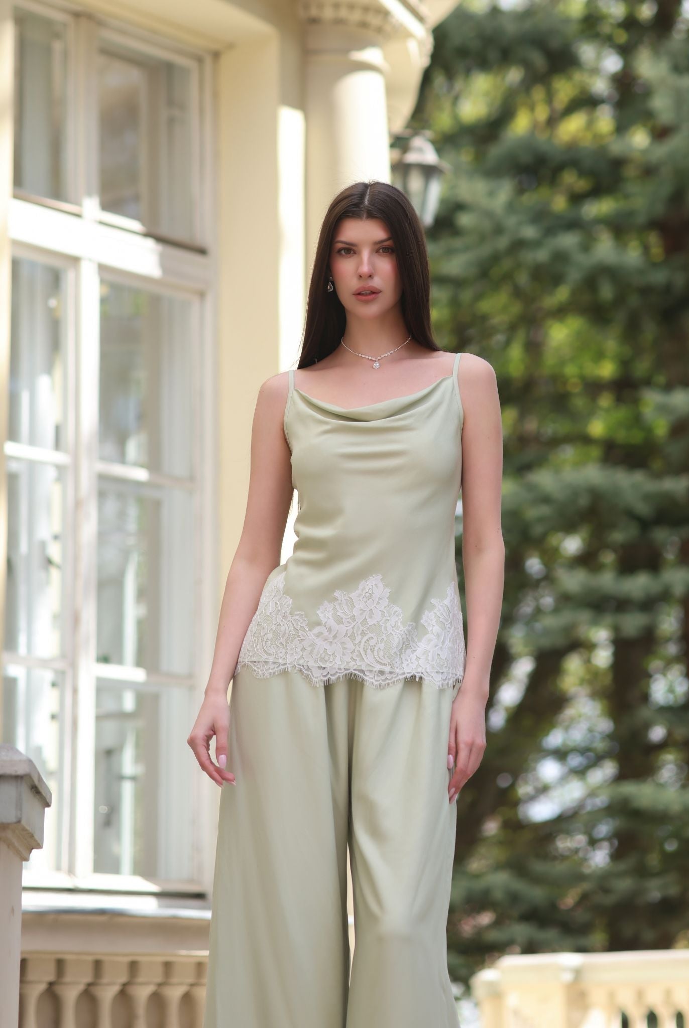 A nearly full-length shot of the tank top and trousers, highlighting the lace-trimmed hem and elastic waistband.