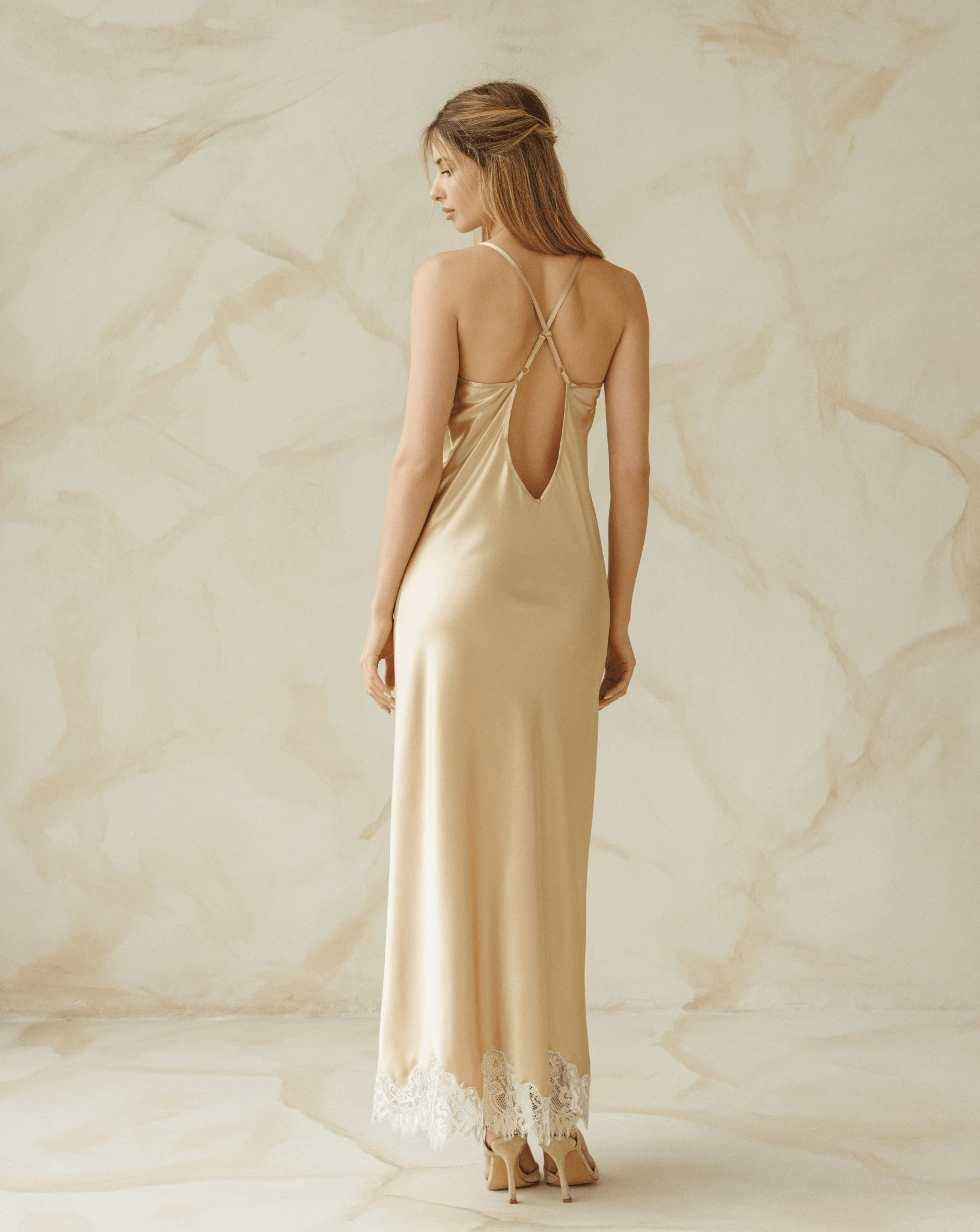 Back view of long satin nightgown with open back and floor-length hem