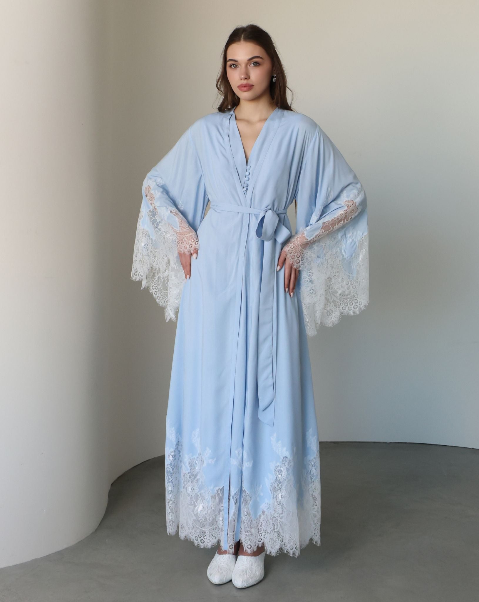 A frontal shot with hands on hips, focusing on the beautiful lace accents and the secure fit of the ties.