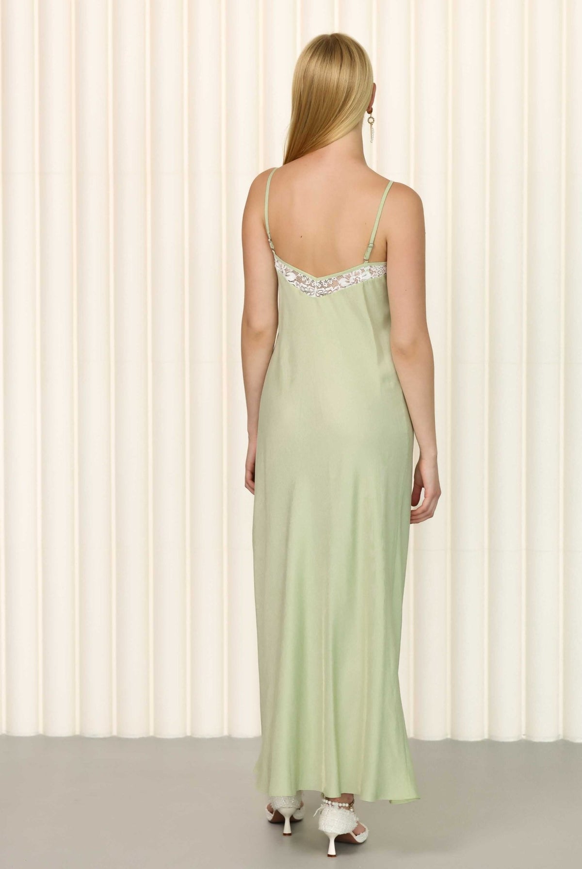 Back view of sage green nightgown with elegant drape