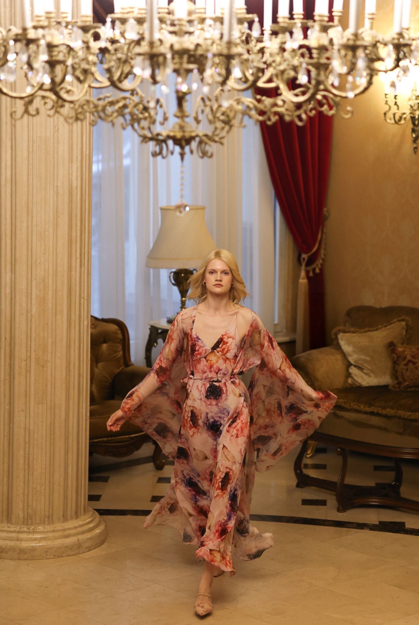 Graceful walk through a hall in a flowing silk garment, showing the effortless movement of high-quality fabrics.