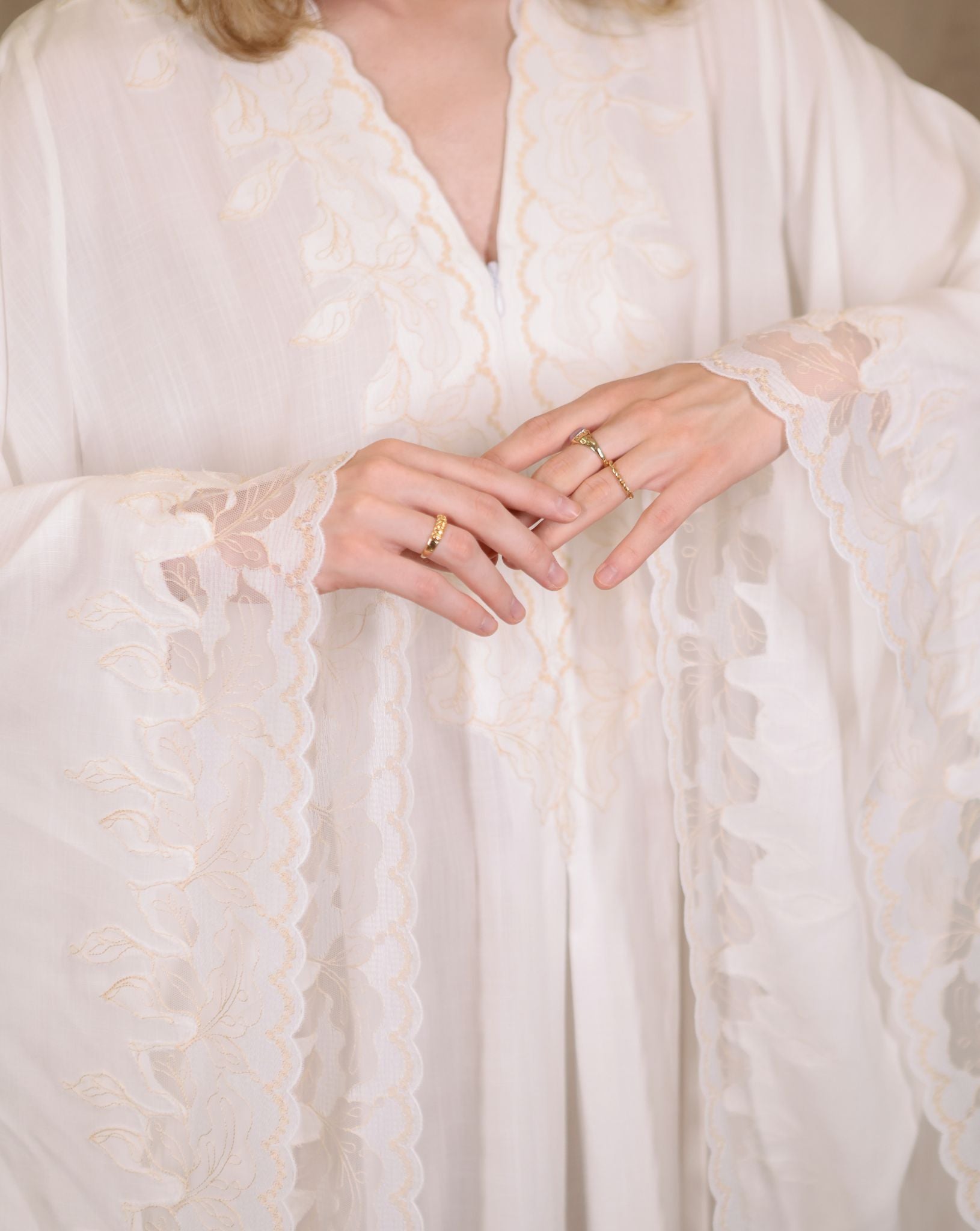 Close-up of lace accents on kaftan sleeves