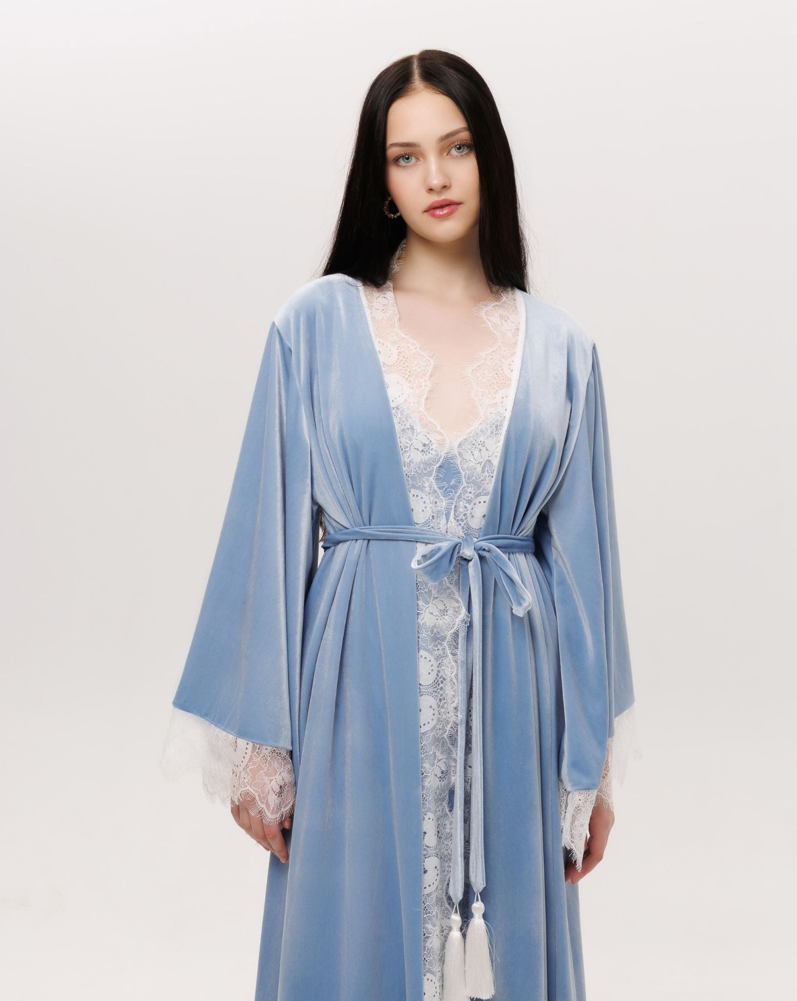 Mid-length shot of the tied robe, featuring delicate lace that traces the sleeves like delicate frost.
