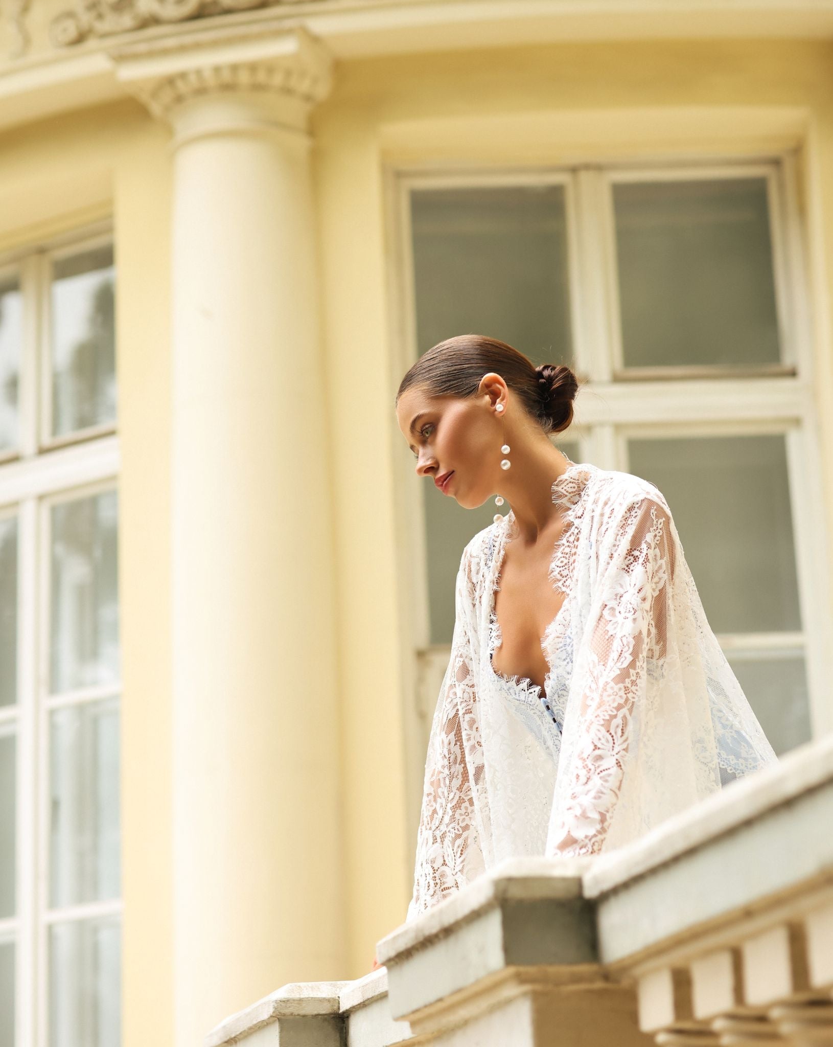 Kafemme lace maternity robe with open front, photographed on a balcony with columns