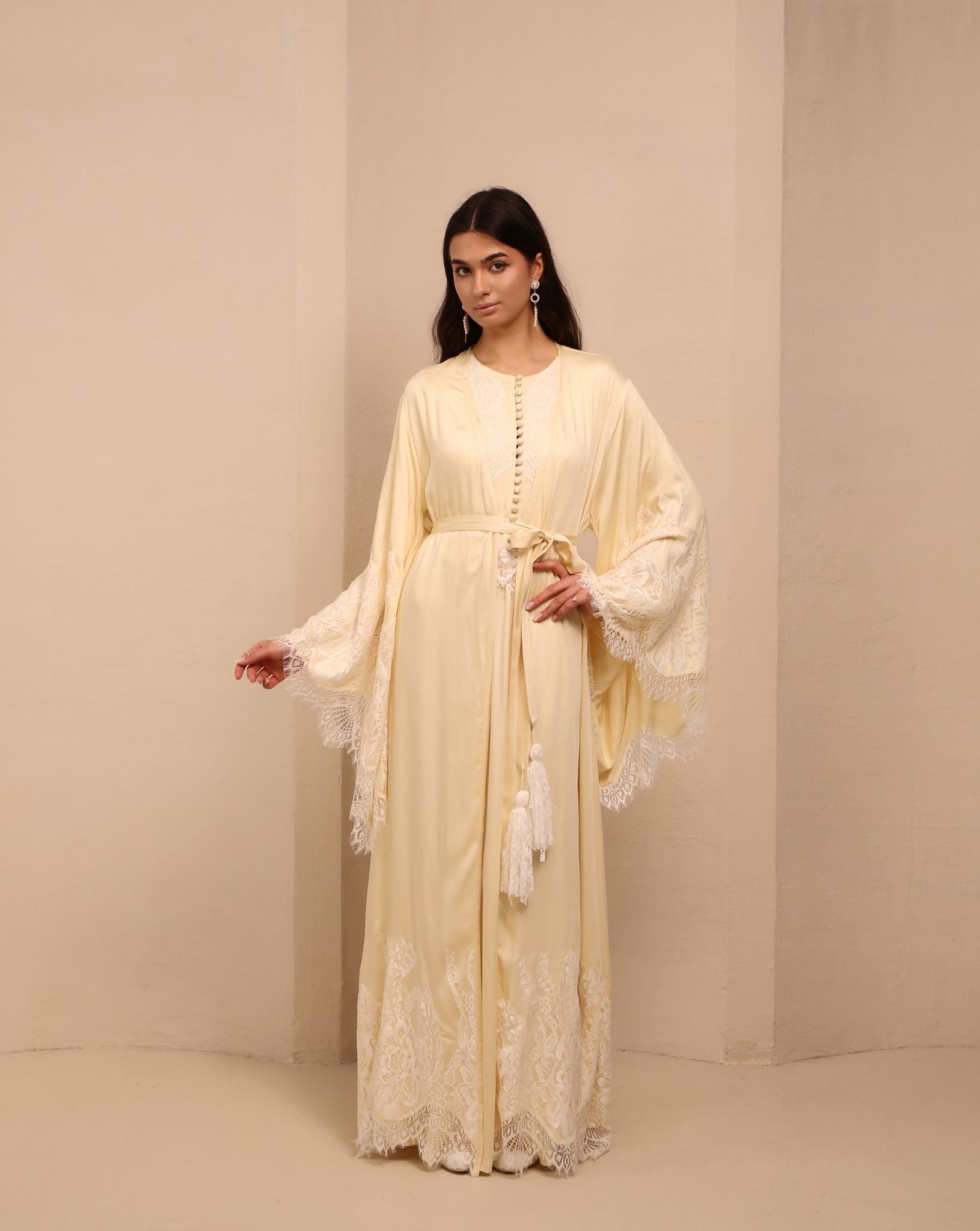 A frontal shot of the ensemble tied with a tassel belt, creating a cozy and feminine silhouette for home.