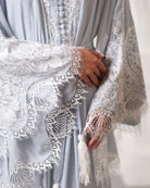 Close-up of the tied waist and lace-covered front of the modest ensemble for a cozy, feminine feel.