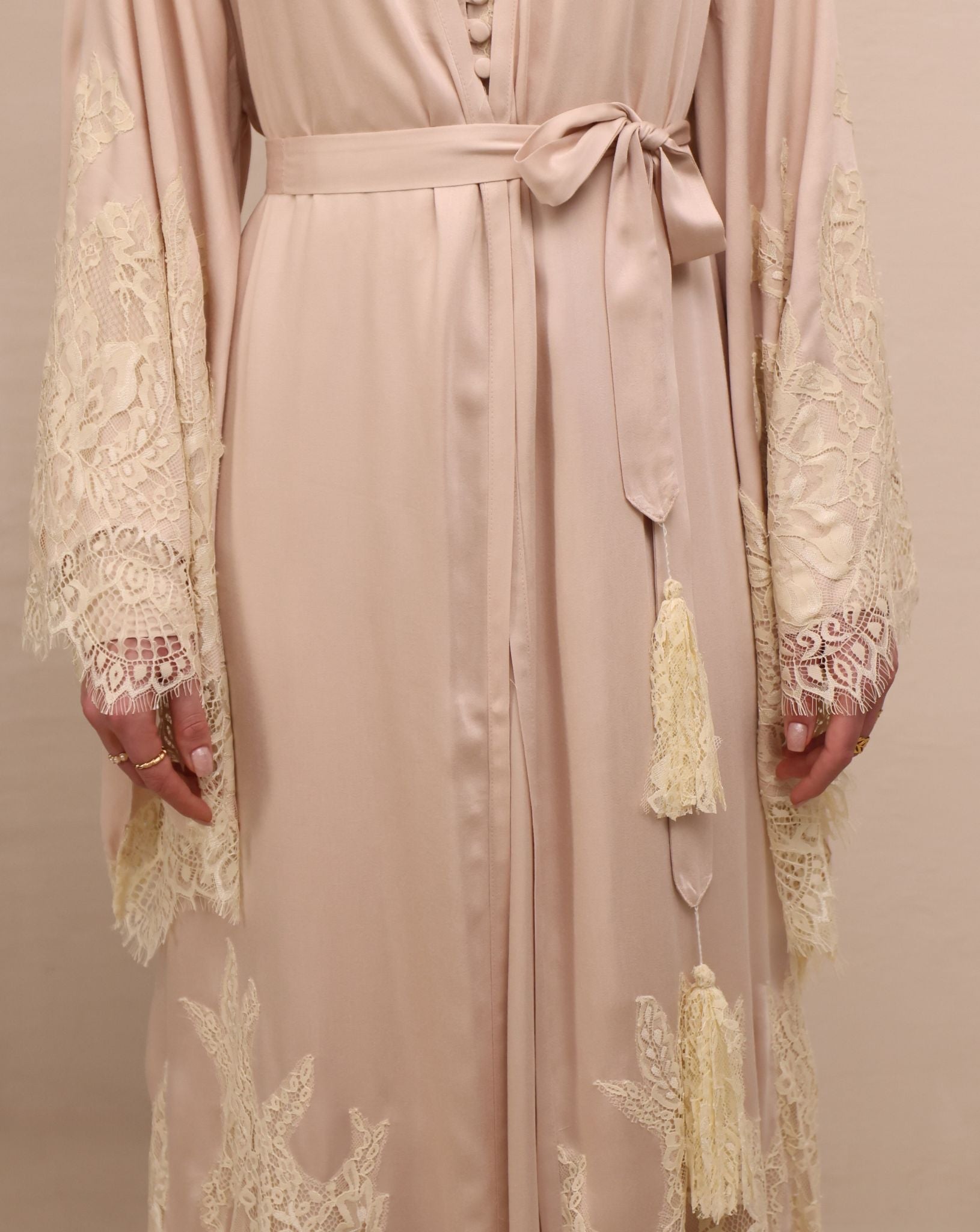 A mid-length shot focusing on the waist, highlighted by simple ties with tassels for an adjustable, relaxed fit.