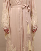 A mid-length shot focusing on the waist, highlighted by simple ties with tassels for an adjustable, relaxed fit.