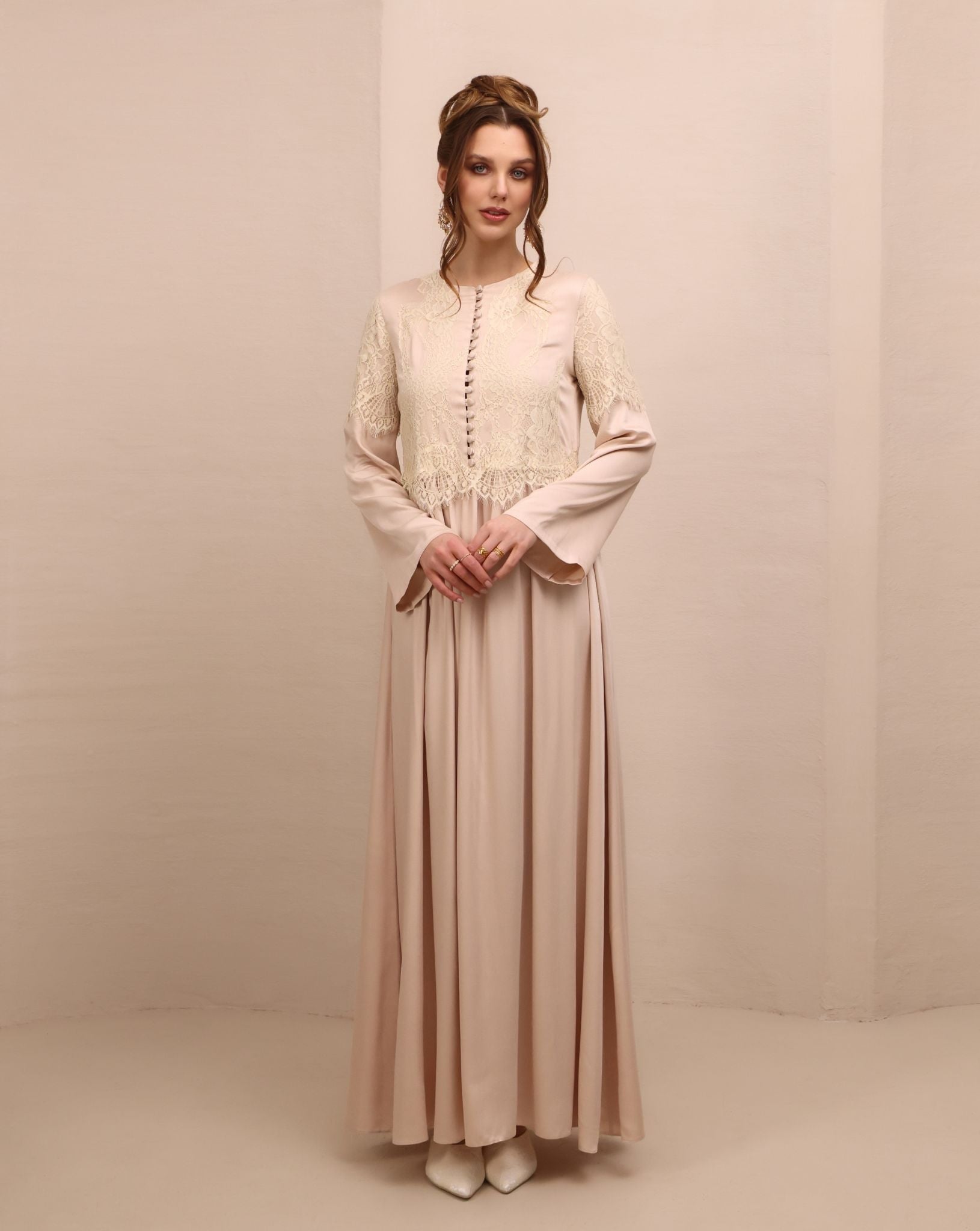 Frontal view of the nightgown, featuring a high neckline, long sleeves, and small buttons covered in fabric.