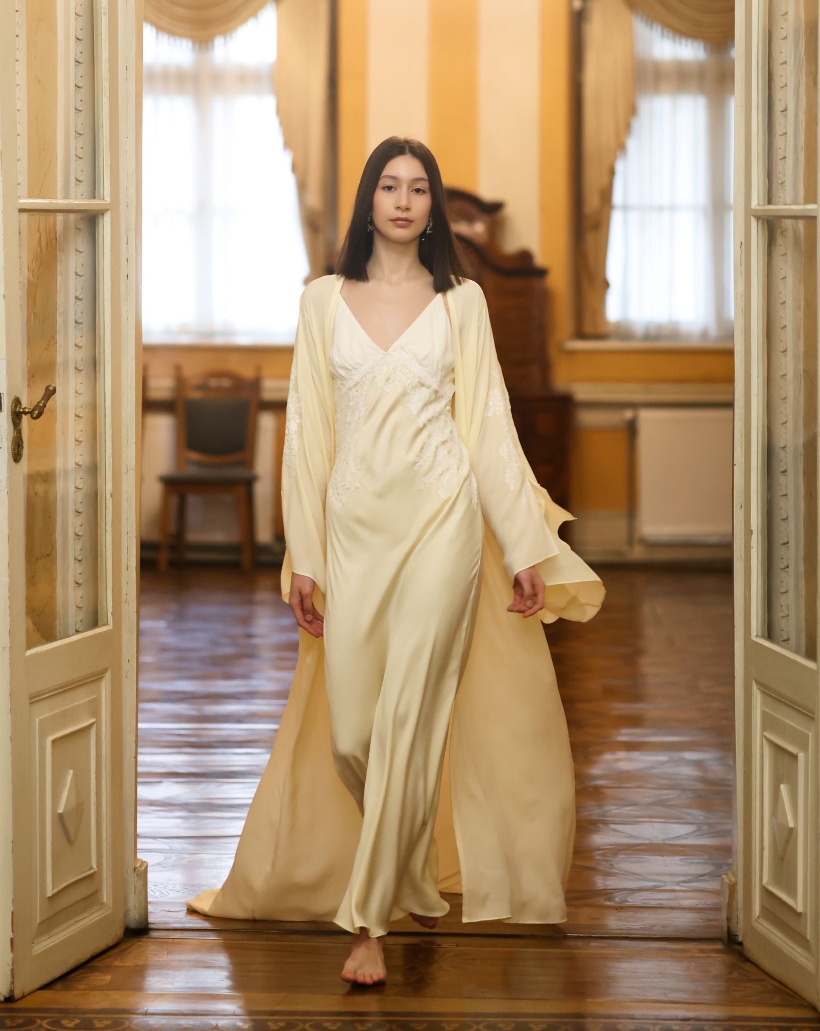 A dynamic view of the sheer chiffon robe in motion, highlighting the slit sleeves and sophisticated drama.