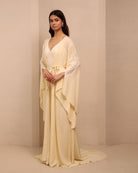 Side perspective of the tied ensemble, showcasing the sleeve slits and the sophisticated drama of the design.