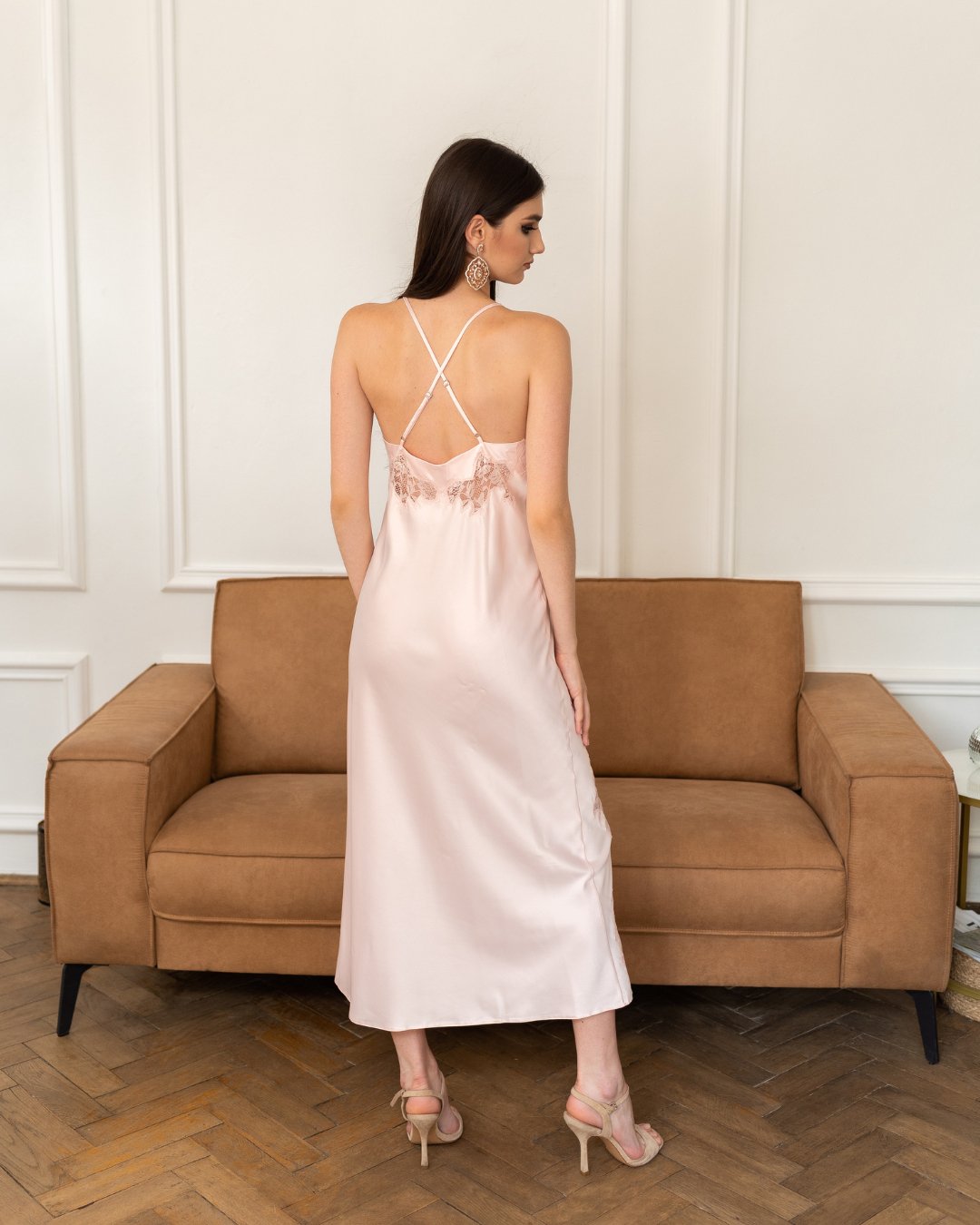 Back view of the satin nightgown, showcasing the alluring strappy back design and fluid fabric.