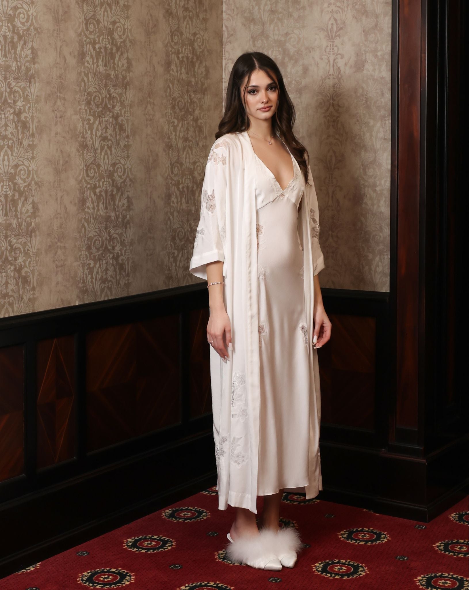 An aesthetic full-height shot from the side, highlighting the soft train of the robe and the elegant silhouette.