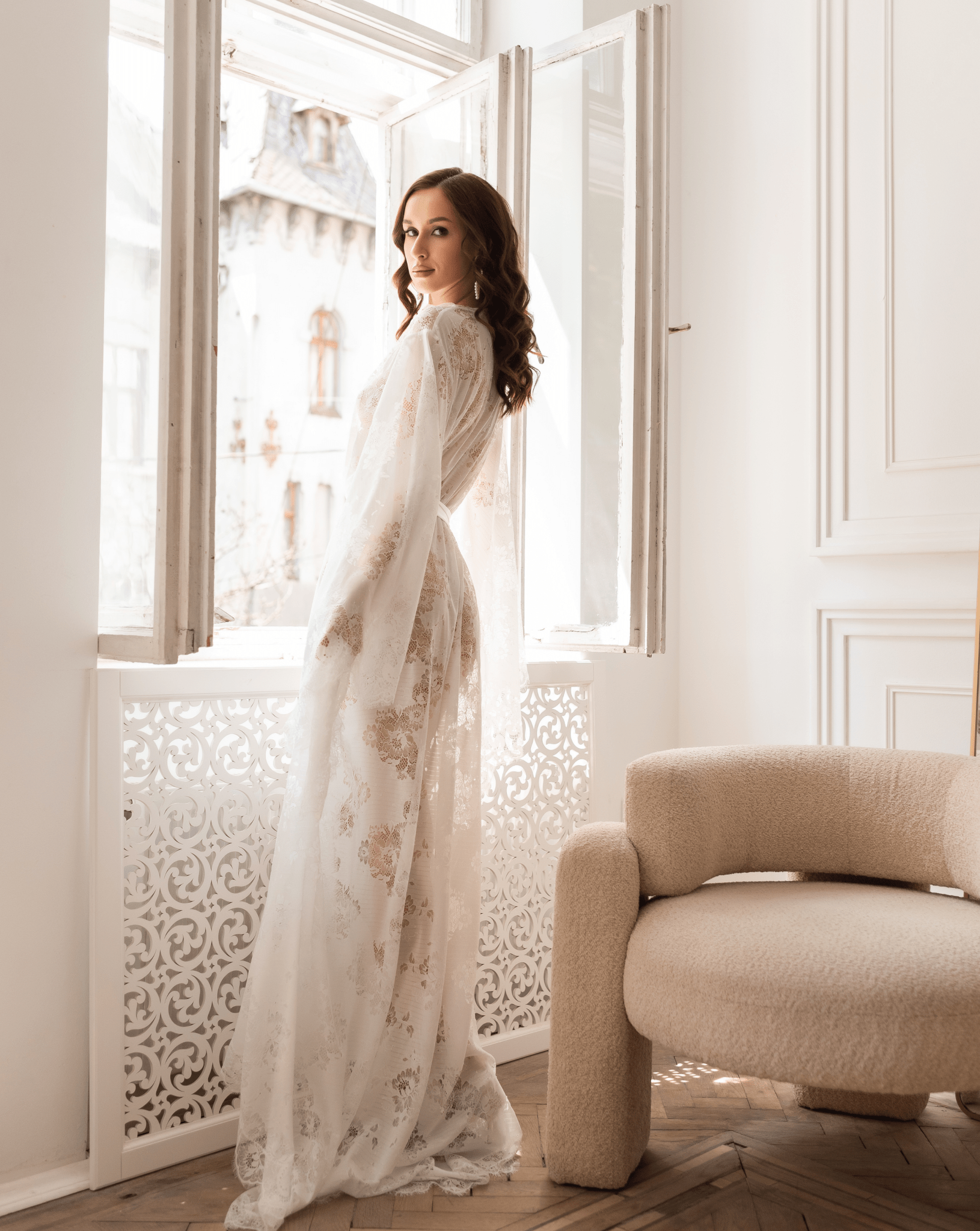 Side view of woman in white lace robe gazing out the window – KÂfemme