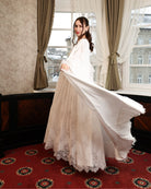 A dynamic "flying" shot of the Cotton Robe and Nightgown Set, capturing the movement of the tiered bell sleeves.