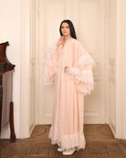 A poised frontal shot of an expecting woman with hands on her belly, highlighting the flattering A-line silhouette.