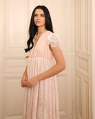 Close-up of the slip dress, featuring buttons along the neckline for discreet and practical breastfeeding access.