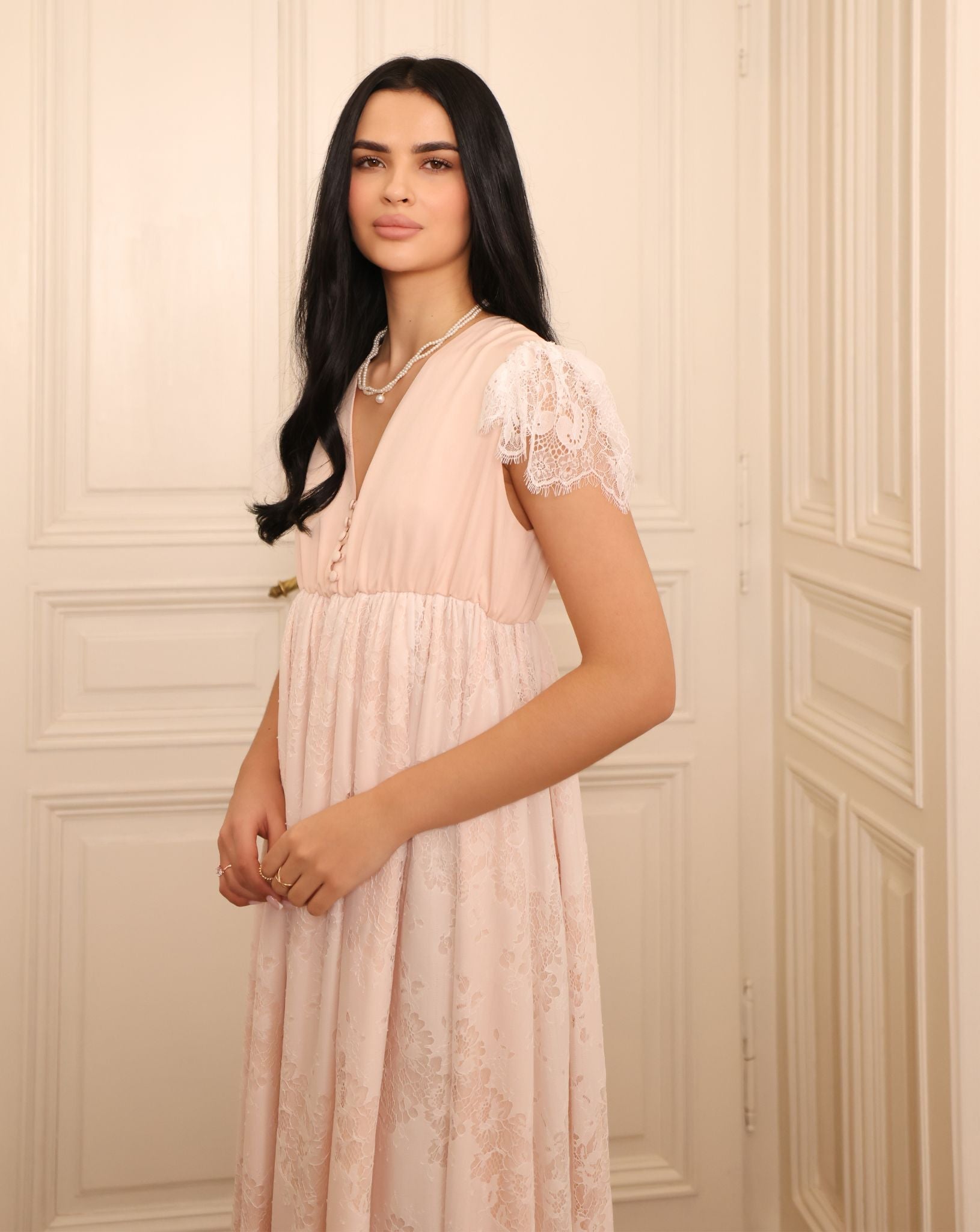 Close-up of the slip dress, featuring buttons along the neckline for discreet and practical breastfeeding access.