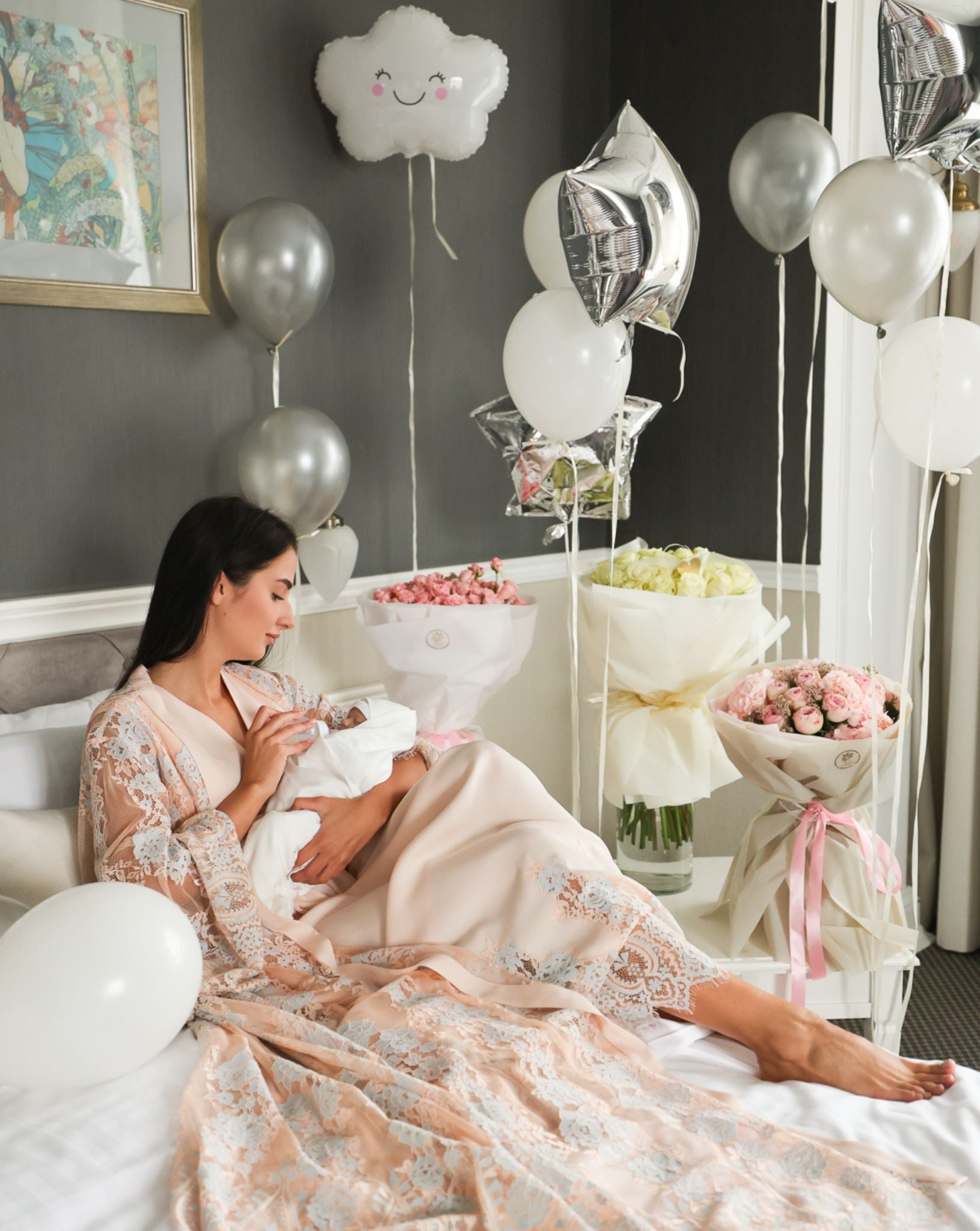Peaceful moment on a bed with a baby, featuring the romantic aesthetic and soft textures of the motherhood ensemble.