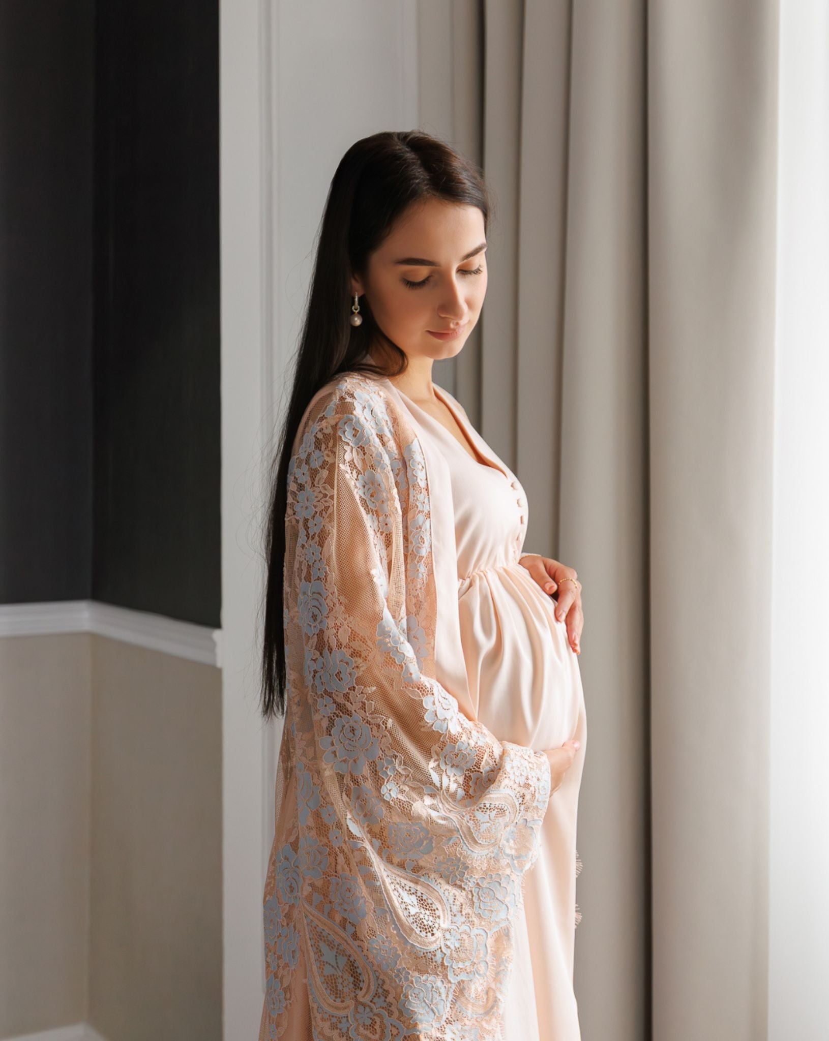 Side profile mid-length view showcasing the delicate lace detailing and the comfortable fit over a growing bump.