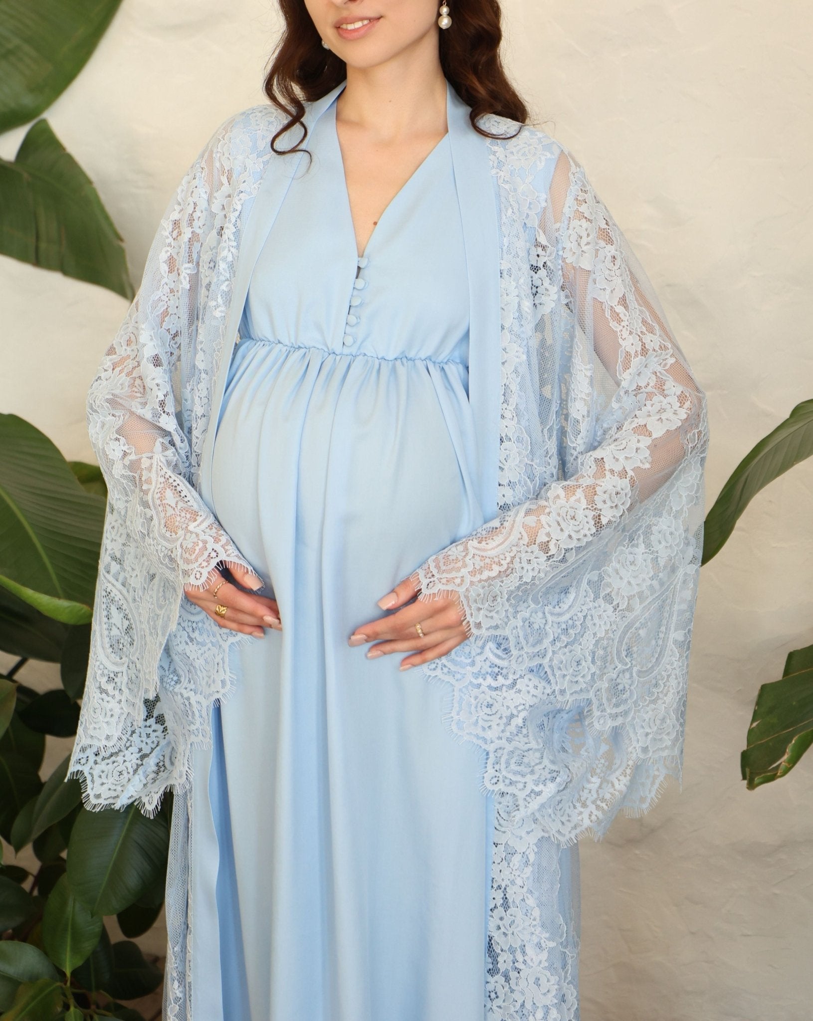 A detailed mid-length shot of the Maternity Robe and Nightgown Set, focusing on the intricate lace and tiny buttons.