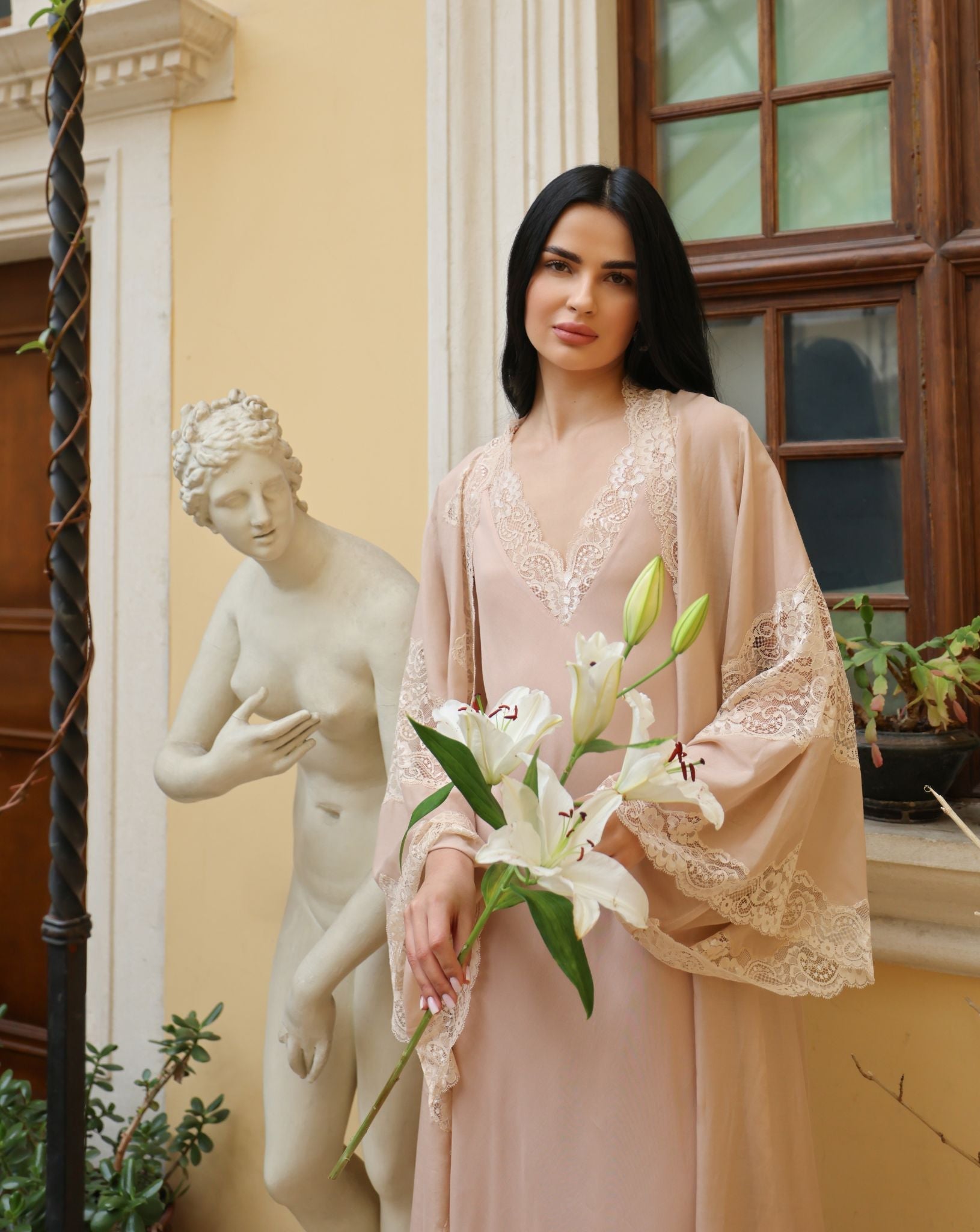 A creative artistic shot featuring a lily, emphasizing the natural ease and exquisite femininity of the collection.