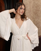 Close-up of the velvet attire, highlighting the luxurious texture and the refined lace details on the sleeves.