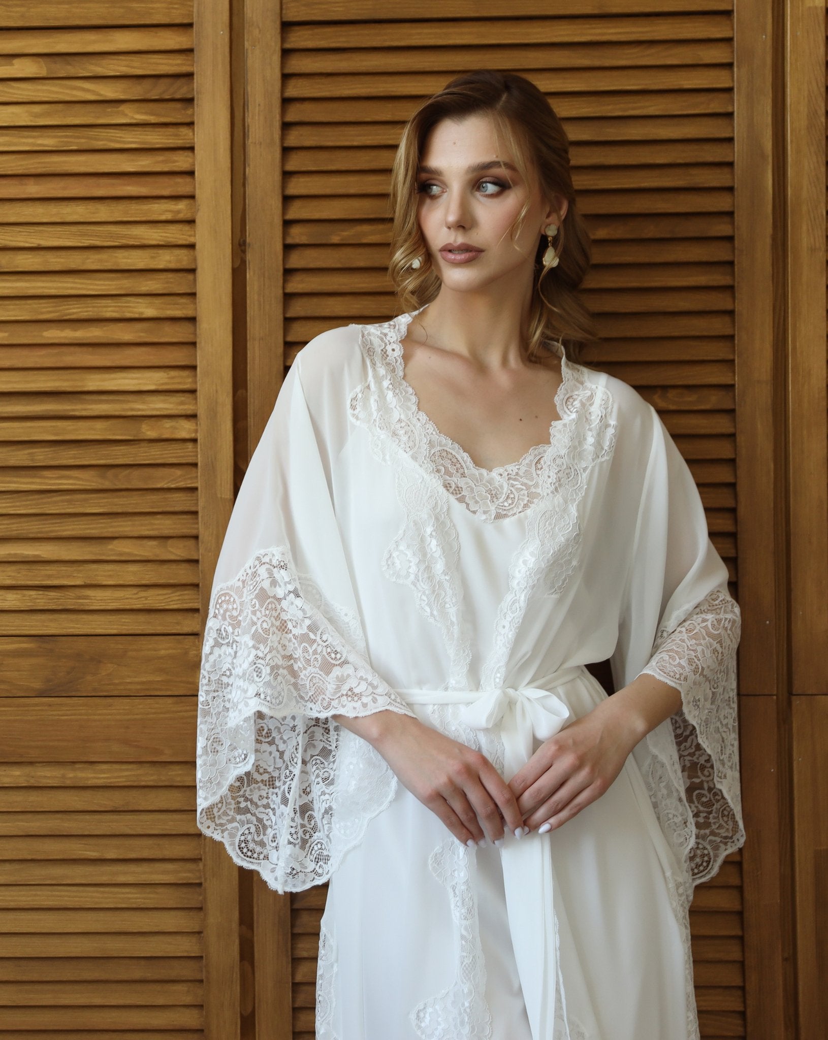 Model in white chiffon robe and nightgown with floral lace details