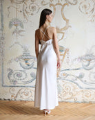 Rear view of the white nightgown showcasing the strappy back design with length regulation and graceful floral details.