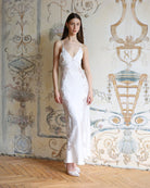 Frontal pose in a white silk-like nightdress with intricate lace cutouts, emphasizing a flattering and serene silhouette.