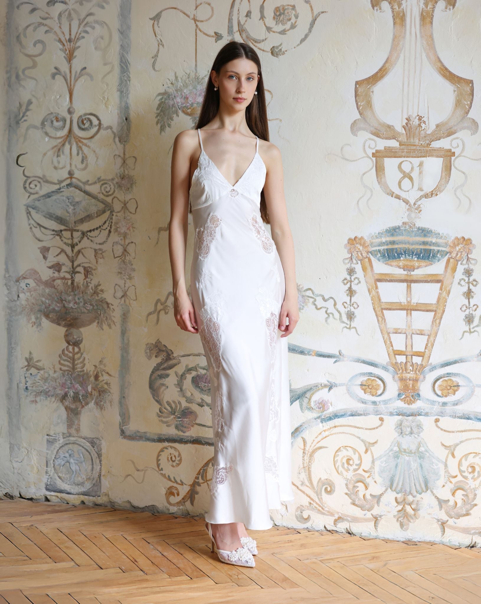 Frontal pose in a white silk-like nightdress with intricate lace cutouts, emphasizing a flattering and serene silhouette.