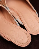 Top view of the footwear without feet, showcasing the brand logo on the leather insole and the classic silhouette.