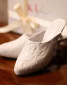 Close-up shot near the packaging, focusing on the carefully balanced elements and the soft lace adornment.