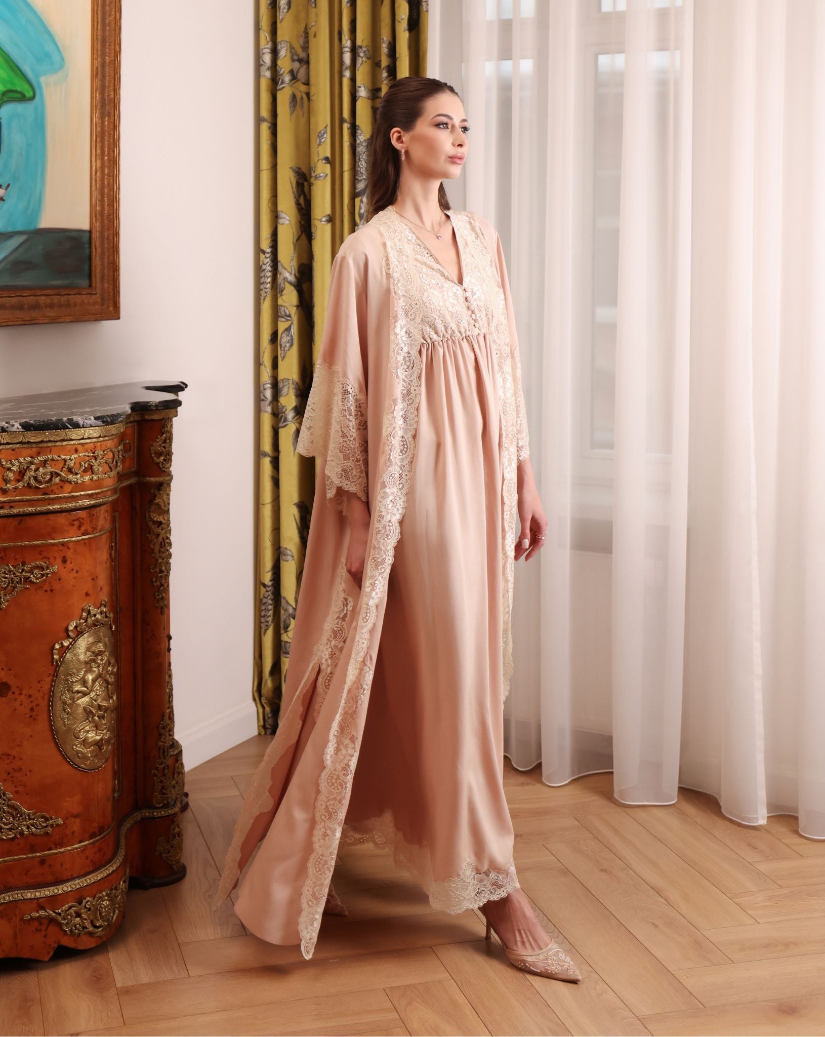 A side-view motion shot of the long robe, wrapping the body in softness that breathes and flows effortlessly.