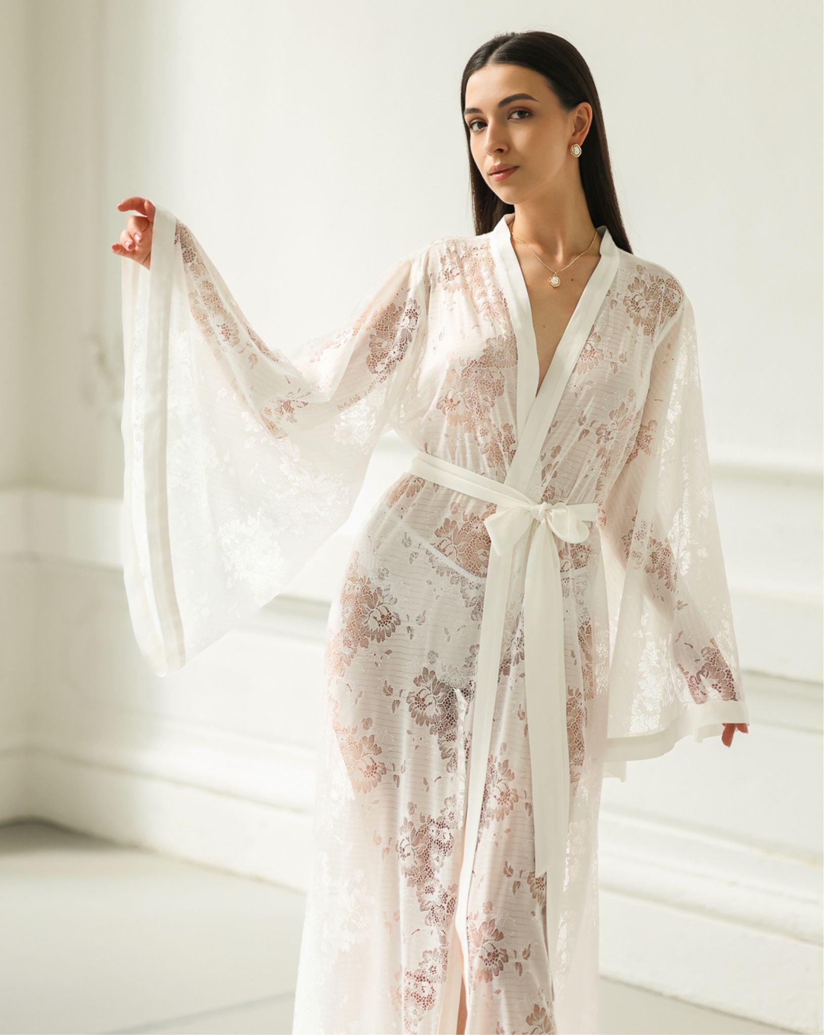 Shot from head to knees, highlighting the intricate cotton embroidery and the delicate texture of the lace fabric.