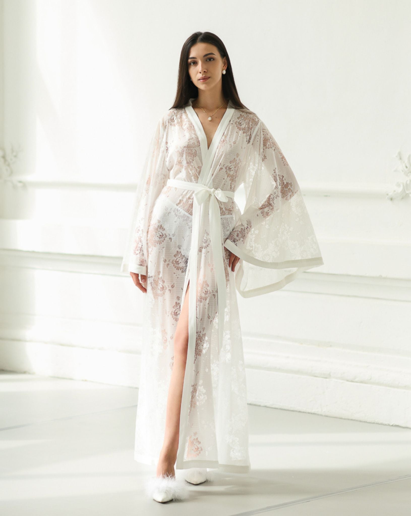 Close-up shot from neck to knees, highlighting the intricate cotton embroidery and the delicate texture of the lace.