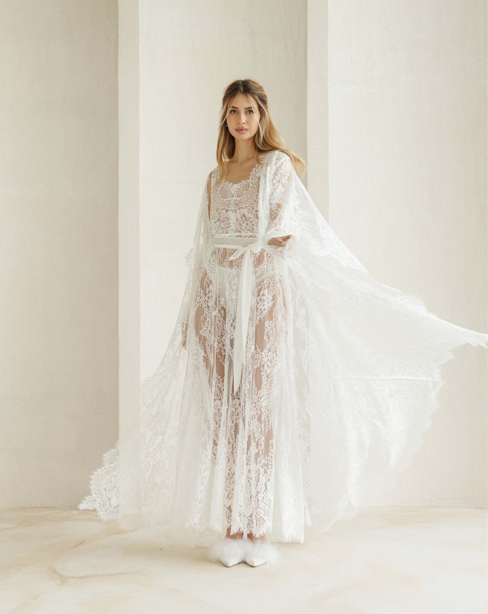 A dynamic view of the Bridal Robe set in motion, capturing how the long hemline flows beautifully as you walk.