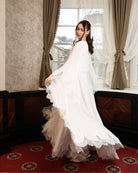 Capturing the visual poetry of the moving robe, illustrating the lightness and femininity of the design.