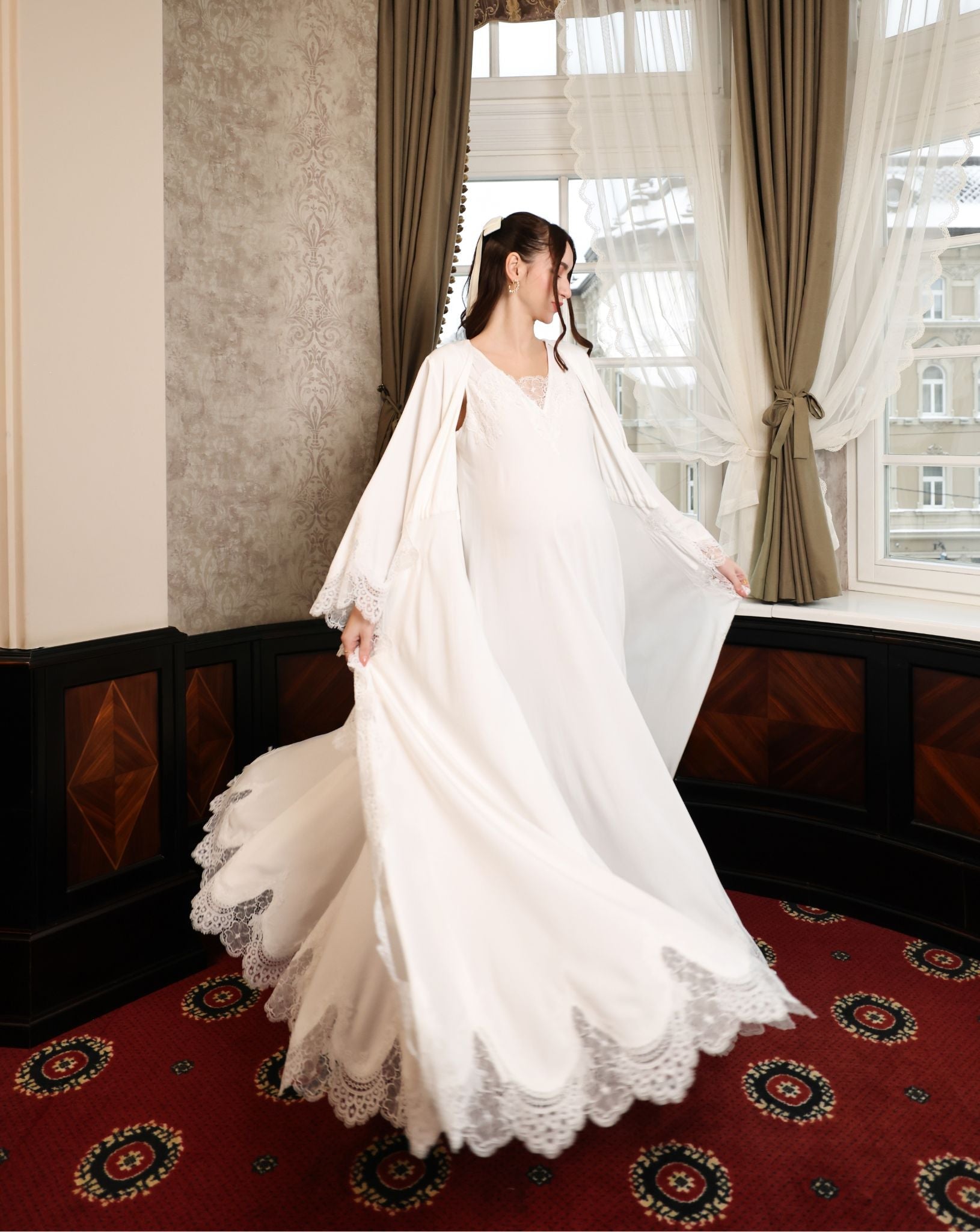 A side perspective of the ensemble during a turn, showcasing how the widened bottom of the robe gracefully moves.