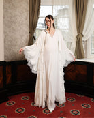 The robe worn open without a sash, focusing on the gracefully flared sleeves and intricate lace embellishment.