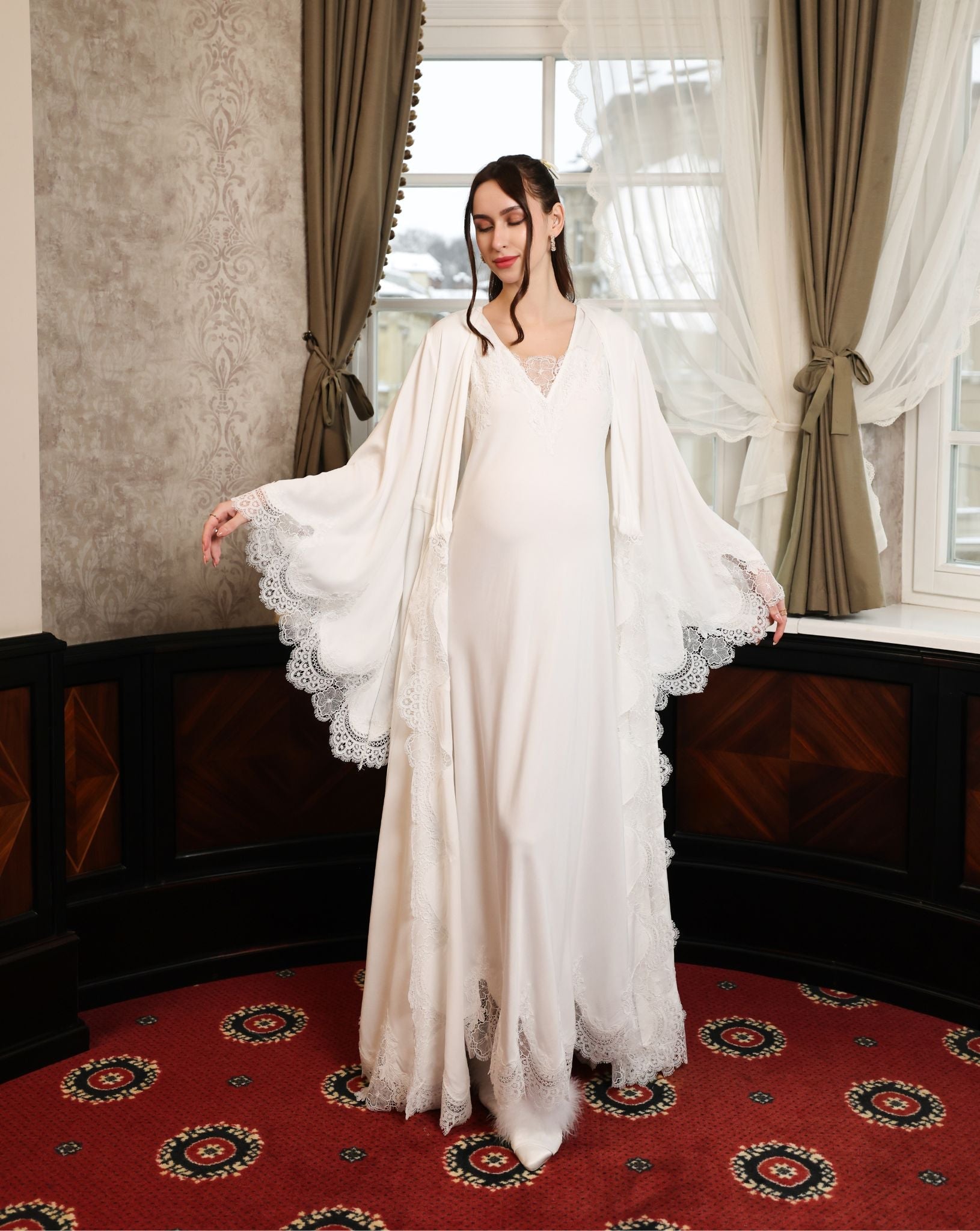 The robe worn open without a sash, focusing on the gracefully flared sleeves and intricate lace embellishment.