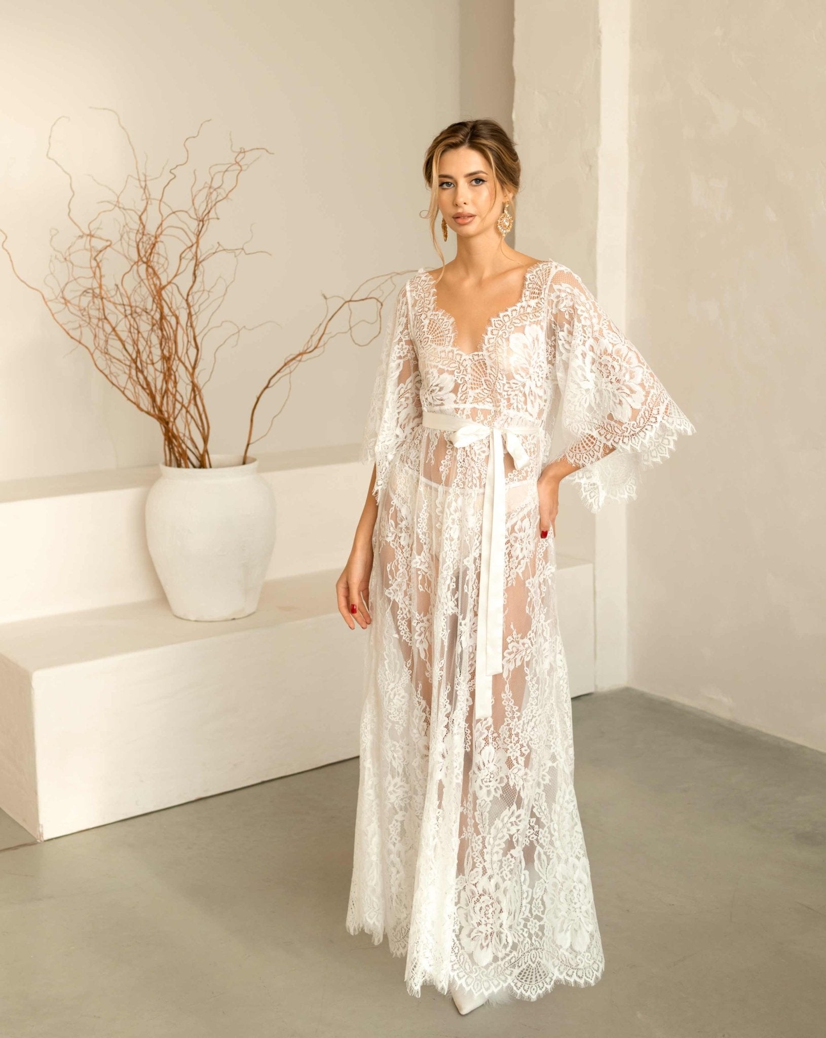 Beautiful model standing in the elegant Wedding Nightgown made of delicate white lace.