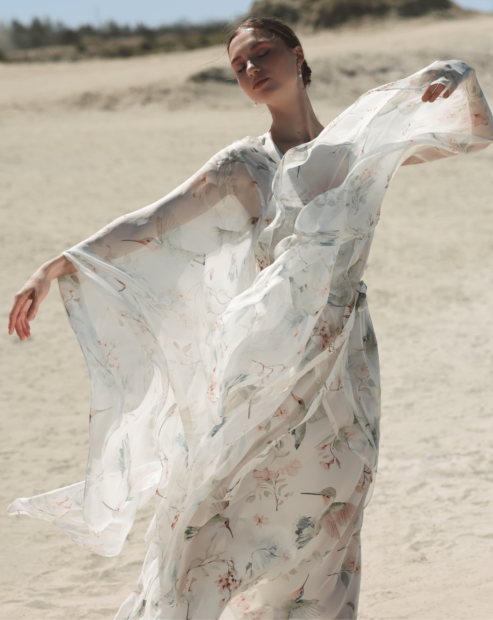 A dynamic view of the attire, highlighting the artistic floral design and the graceful movement of the pure silk fabrics.