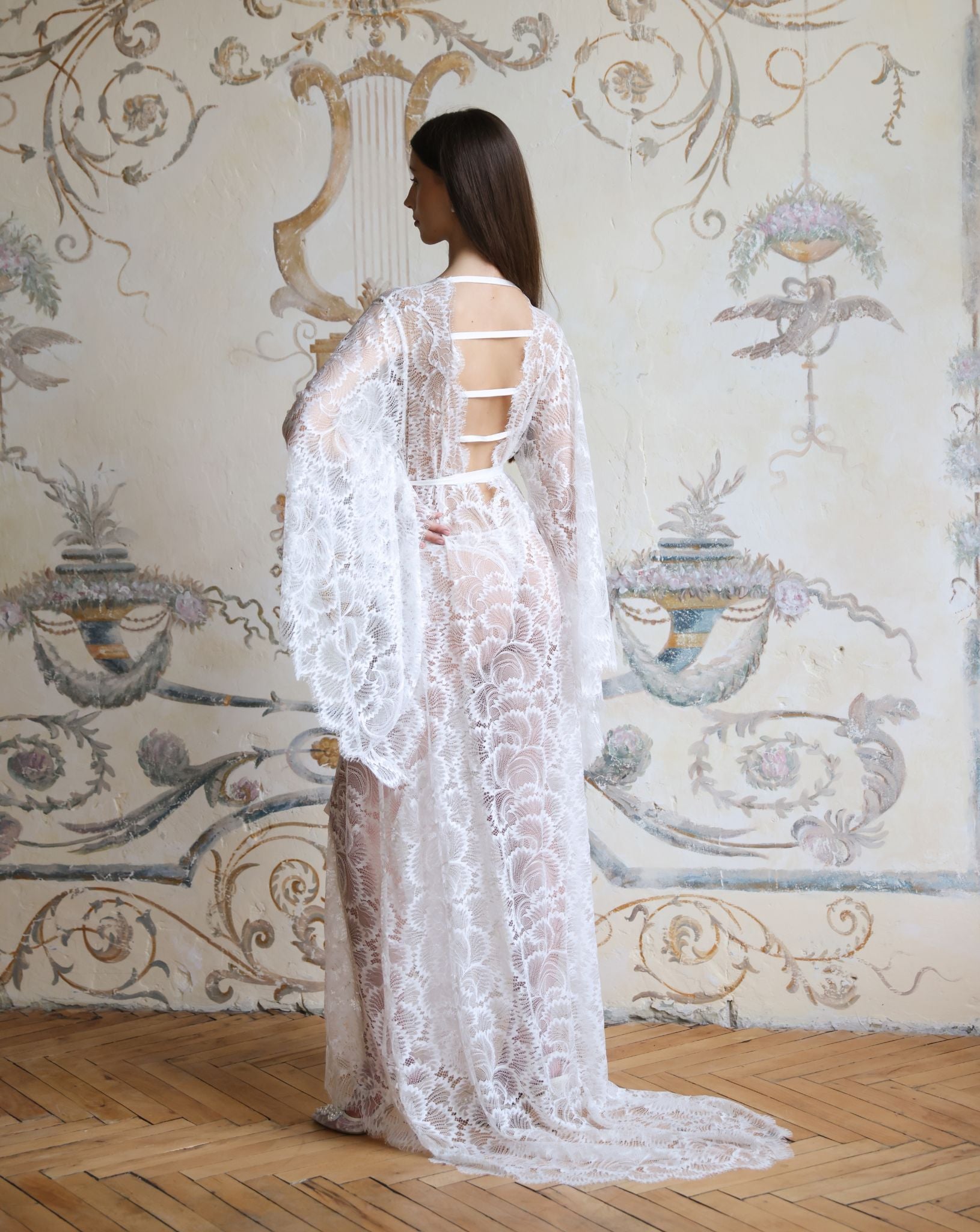 Rear view of the Lace Bridal Robe, showcasing the dramatic long train and refined back strap details.