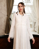 A mid-length view with hands down, emphasizing the modest cut and the seamless lace coverage across the silhouette.