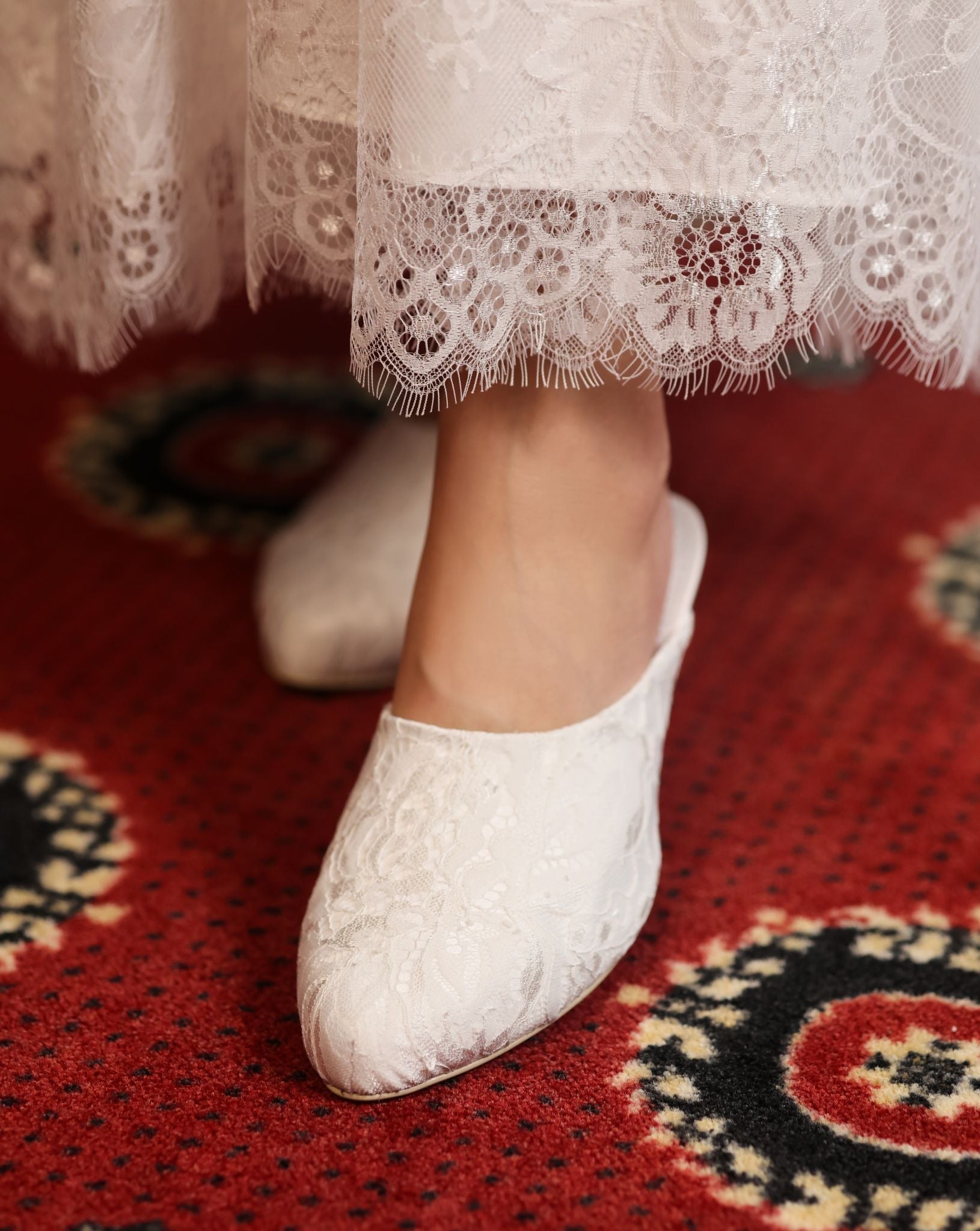 Detailed shot of the lace hem and footwear, capturing the timelessly feminine and light feel of the layered skirt.