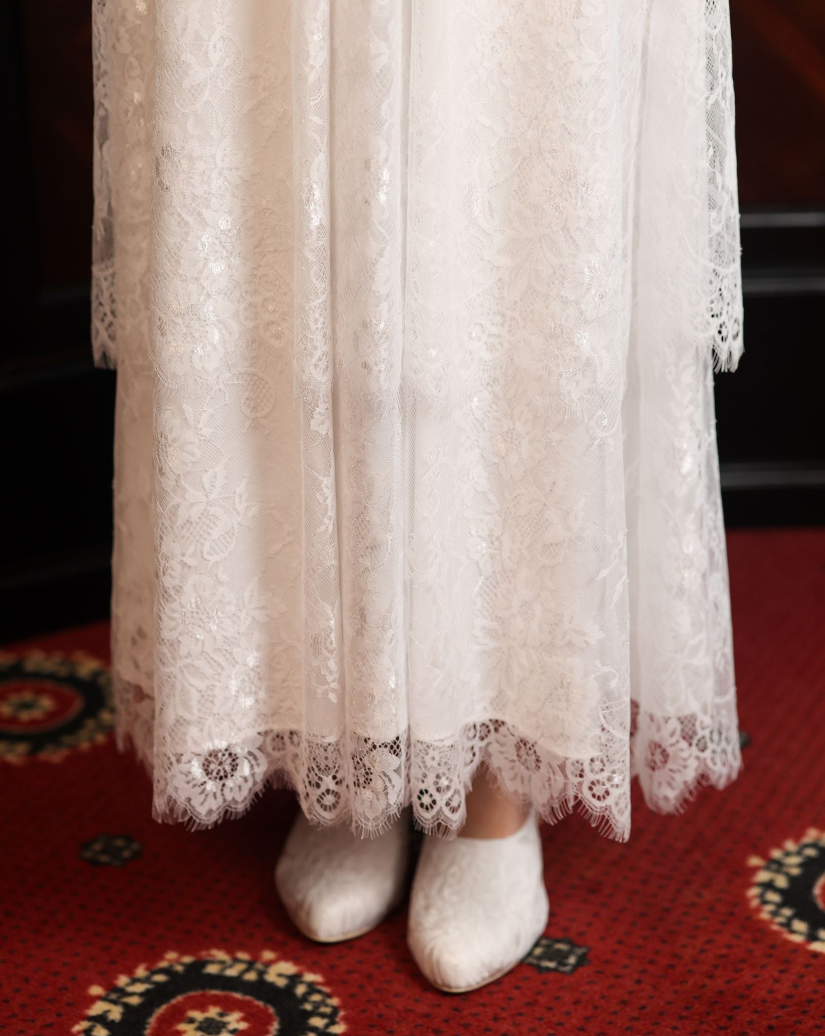 Close-up of the Modest Lounge Dress skirt, highlighting the depth of the two layers of lace and its romantic texture.