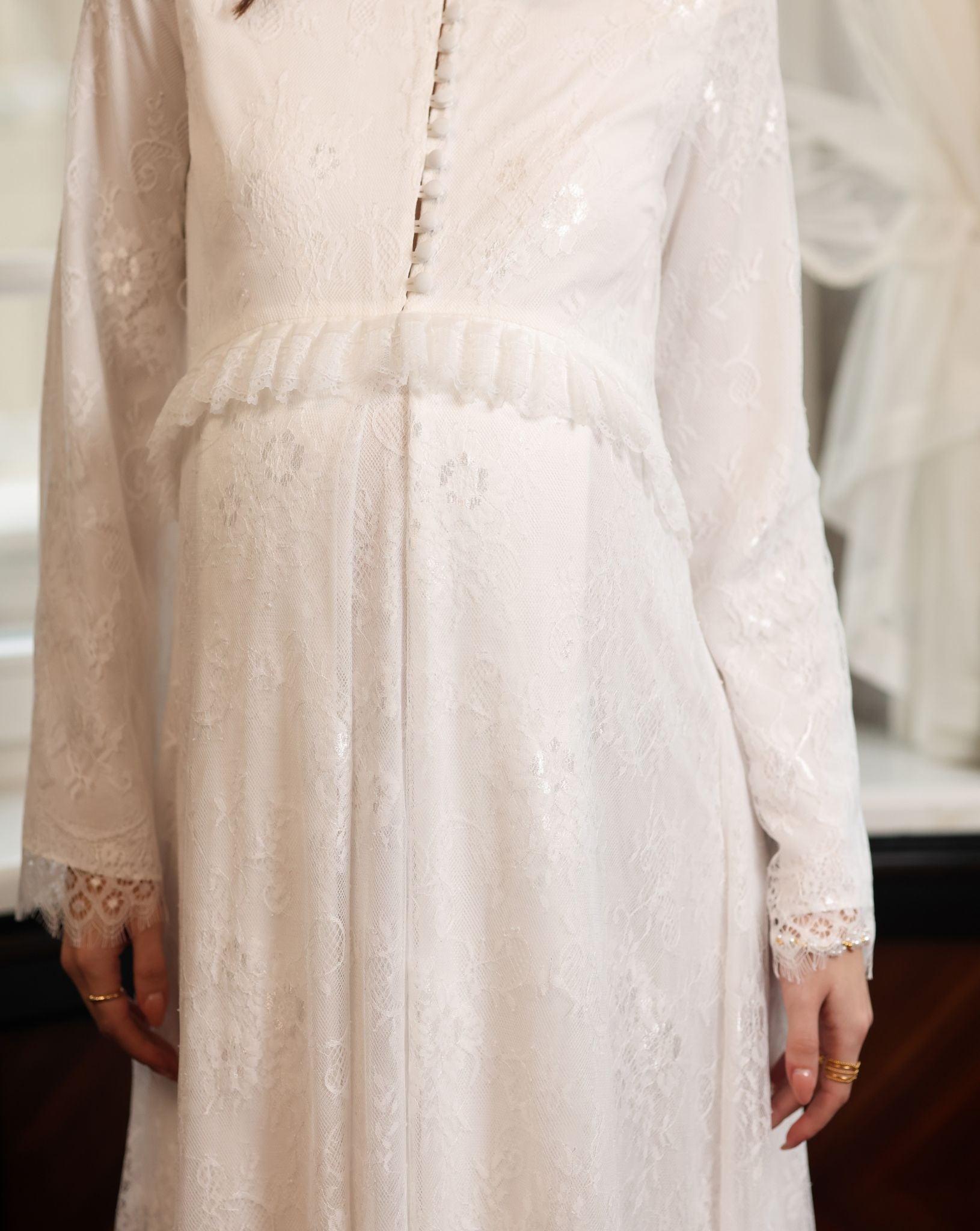 Close-up of the Modest Lounge Dress bodice, featuring satin buttons for discreet nursing access and a ruffled waist.