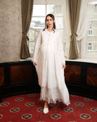 A dynamic view of the floor-length gown in motion, illustrating the weightless and fluid movement of the lace layers.